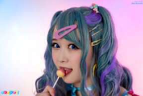 Ria Kurumi sucks lollipop while stripping dress and showing her shaved pussy