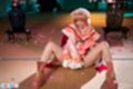 Misa seated with knees drawn up looking down between her legs
