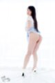 Leaning forward looking over her shoulder long hair down her back skirt raised pert ass wearing high heels