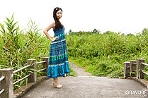 Standing on footbridge hands on hips long hair wearing high heels