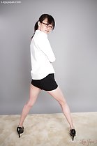 Looking back wearing short skirt legs spread high heels