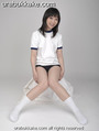 Kogal seated in gym class uniform knees pressed together.jpg